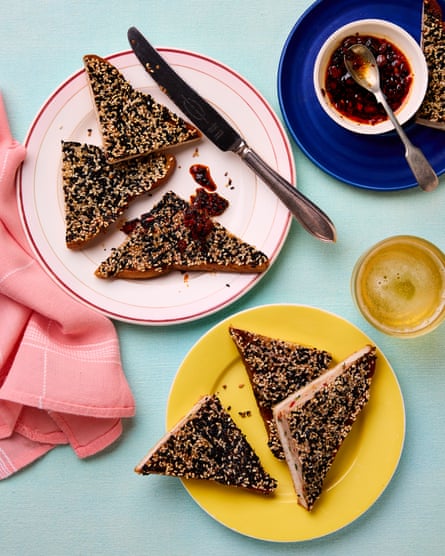 Triangles of toast coated in sesame seeds sit on plates