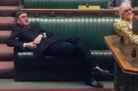 Jacob Rees-Mogg lying back with his eyes nearly shut on the front benches of the House of Commons, while Nadine Dorries sits to his left holding her fingers to her mouth
