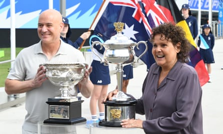 Four-time AO champions Andre Agassi and Evonne Goolagong Cawley take on Norman Brooks Challenge Cup and Daphne Akers on day one at Melbourne Park Photo with special commemorative cup.