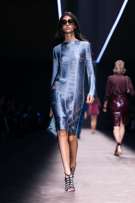Model wearing a blue slinky dress.