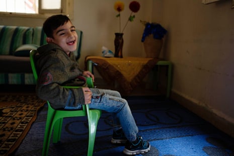 Ghazzi, who is eight years old and has cerebral palsy, in the apartment where he lives with his parents and six siblings in Beirut, Lebanon, 24 March 2021