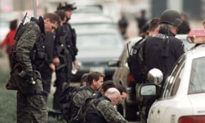 Members of a police SWAT team take a break in front of Columbine High School, after the shooting stopped.