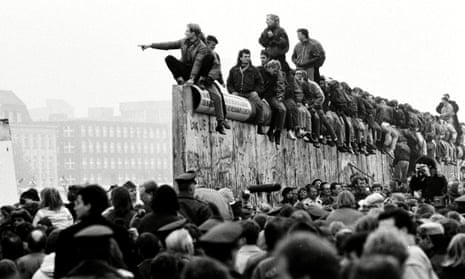  East and West German people celebrate the end of cold war on top of the Berlin Wall, East Berlin, Germany 10 Nov 1989