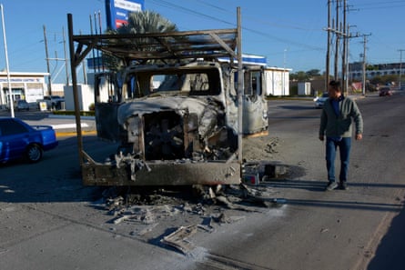 A charred cargo vehicle in Culiacán, in the Mexican state of Sinaloa, on 6 January 2023 after gunmen fought with police following the arrest of Ovidio Guzmán, one of the sons of Joaquín ‘El Chapo’ Guzmán.