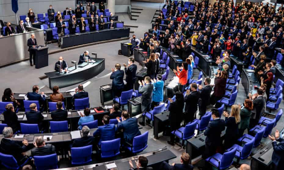 The German chancellor, Olaf Scholz, receives a standing ovation after delivering a speech on the Russian invasion of the Ukraine during a meeting of the German federal parliament.
