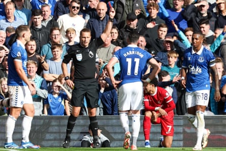 Everton’s Ashley Young (right) is shown a red card by Craig Pawson.