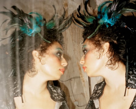 Celeste looking at her reflection in a mirror.