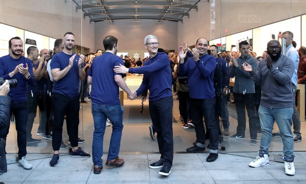 Apple CEO Tim Cook greets customers as the Palo Alto, California, store’s employees clap their arrival to purchase the new iPhone X.