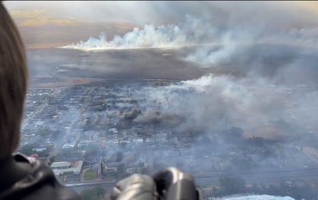 This handout video grab courtesy of Richard Olsten taken on 9 August 2023 shows smoke billowing from destroyed buildings as wildfires burn across Maui, Hawaii.