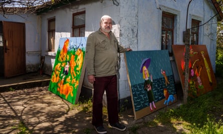 Moldovanov with some his paintings outside his home