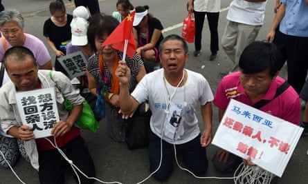 Tearful relatives demonstrate outside Malaysia’s embassy in Beijing in 2015.