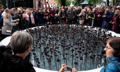 People gather at an ‘iron roses’ memorial outside Oslo cathedral on the anniversary of the attacks by Anders Breivik. 
