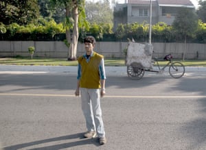 Waste collector Rajeev Kumar, 20, and his cart in an affluent suburb of Delhi, 2008