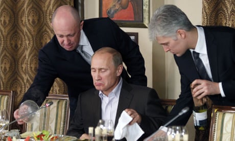 Yevgeny Prigozhin, left, serving food to Vladimir Putin at a restaurant outside Moscow in 2011.