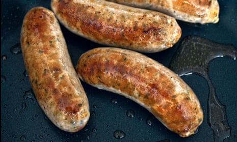 Sausages cooking in a frying pan
