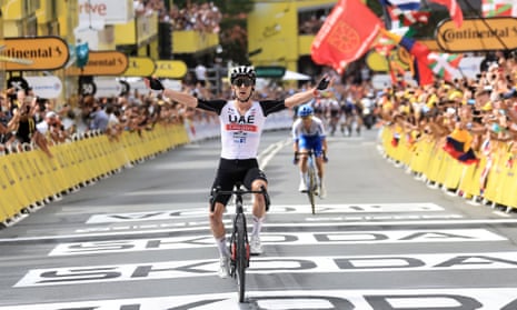 Adam Yates celebrates as he crosses the finish line to win the first stage of the Tour de France 2023.