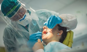Dentist examines patient