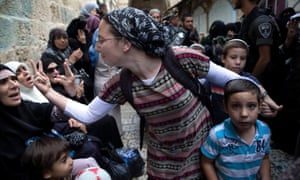 an israeli woman and a palestinian woman gesture at each other at a protest in jerusalems old city