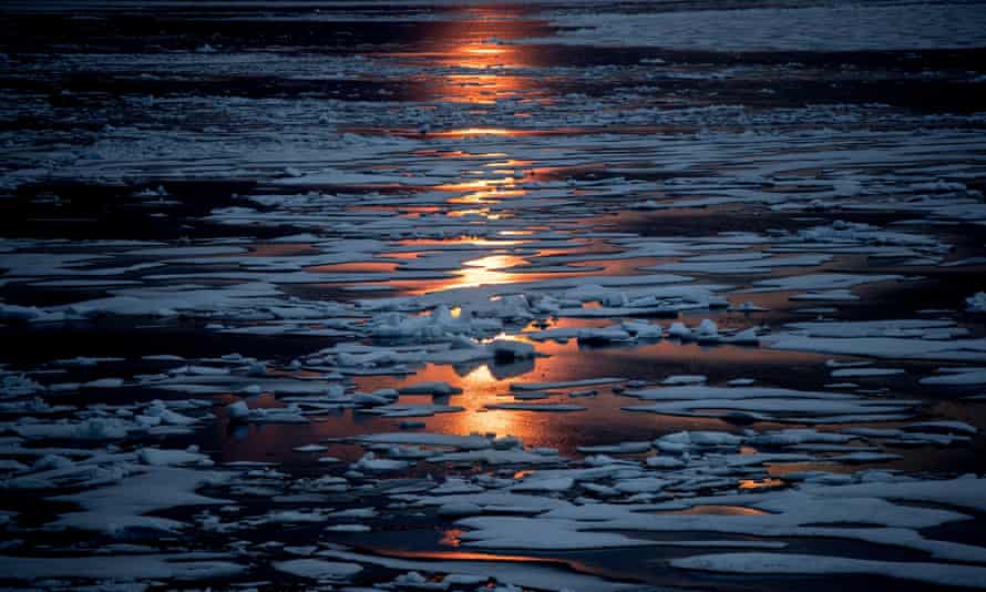 The midnight sun shines across melting sea ice in the Canadian Arctic archipelago.