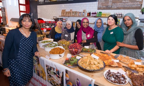 Kalpna Woolf, left, with some of the cooks and their food at the International Peace Cafe, Bristol.
