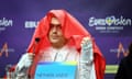 Joost Klein at a Eurovision press conference with red fabric covering his head