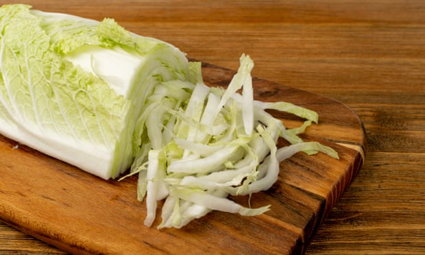 Chopped Chinese Cabbage, Napa Cabbage or Wombok on Wood Cutting Board Background