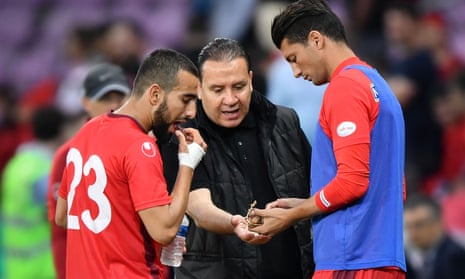 Tunisia’s head coach Nabil Maâloul distributes dates to  midfielder Naïm Sliti, left, and defender Rami Bedoui during the friendly with Turkey. Maâloul said he had asked his goalkeeper, Mouez Hassen, to simulate an injury in warm-up games to allow his players to break the fast