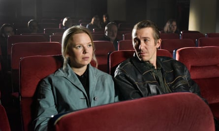 still from film with two people sitting in a cinema