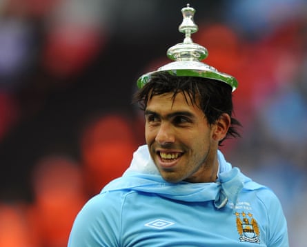 Carlos Tevez celebrates with the FA Cup lid in 2011.