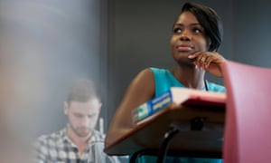 University student sitting at desk with hand on chin. Image shot 2014. Exact date unknown.<br>Female university student
