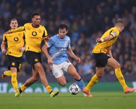 Nico González dribbles the ball through opposition players during the Champions League match between Manchester City and Borussia Dortmund