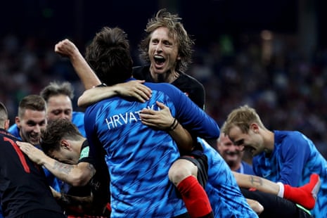 Luka Modric celebrates with teammates following their victory.