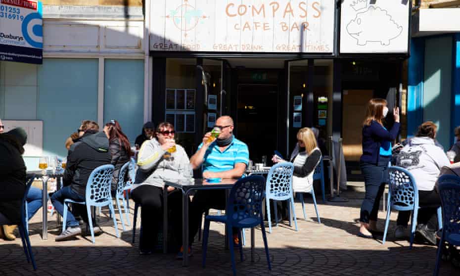 People enjoy drinks in the sunshine outside a bar near the Winter Gardens Blackpool.