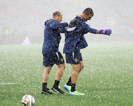 Portugal keeper Diogo Costa leaves the pitch after hail interrupts his warm-up.