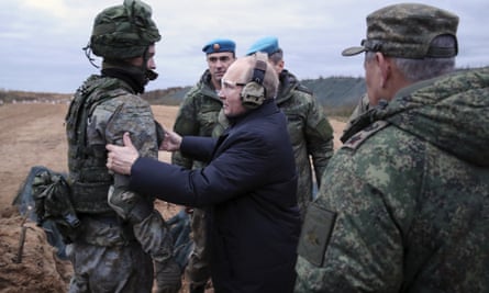 Vladimir Putin speaks to a soldier