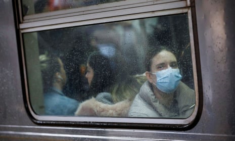 A woman wears a face mask on the subway in New York, New York, on 13 March.