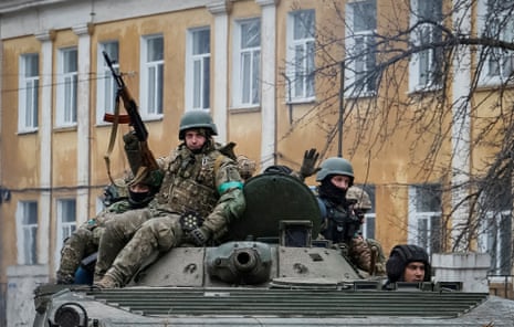 Ukrainian forces ride a BMP-1 infantry fighting vehicle in the city of Chasiv Yar.