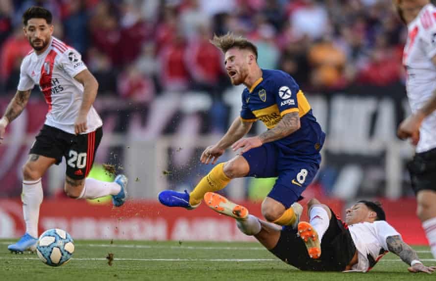 Alexis Mac Allister is feels the force of a River Plate tackle while playing for Boca Juniors in September 2019.