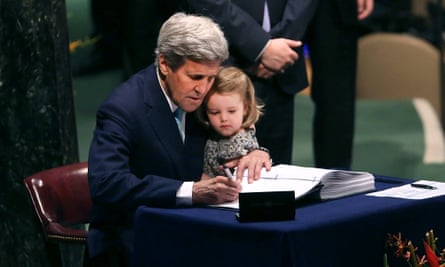 Kerry holds his two year-old granddaughter for the signing of the 2016 Paris climate agreement.