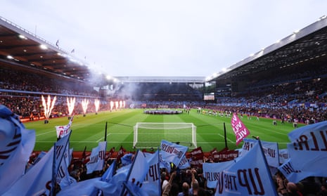 Fans wave flags in support of their teams as the players take to the pitch ahead of the Premier League match between Aston Villa and Liverpool at Villa Park.