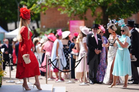 A racegoer poses for a photograph during day one of Royal Ascot.