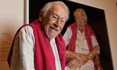 Guy Warren in front of his portrait by artist Peter Wegner that won the 2021 Archibald prize at the Art Gallery of NSW in Sydney, Australia