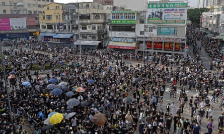 Protesters march in an area of Hong Kong popular with Chinese tourists for its pharmacies and cosmetic shops on Saturday.