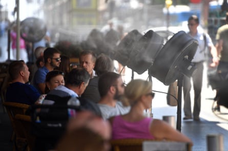 Fans spray cold water on customers on the terrace of the Círculo de Bellas Artes bar in Madrid.
