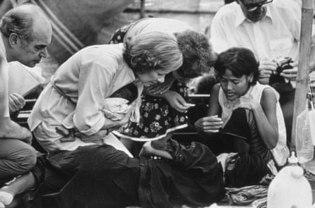 Rosalynn Carter, with a baby in her arms, speaks to the child’s mother at the Sa Kaeo refugee camp in the Prachinburi province (later Sa Kaeo), Thailand, on 9 November 1979.