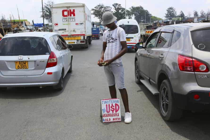 A currency trader counts his money in Harare