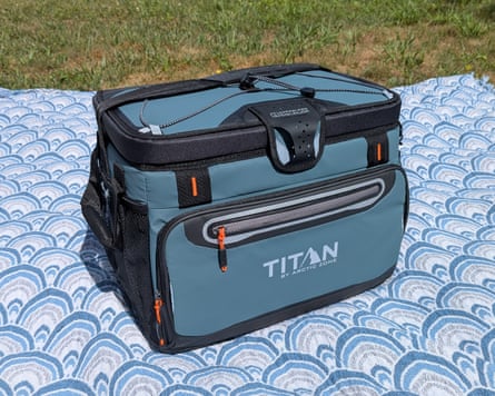 blue cooler on blanket in grass