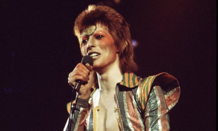 David Bowie sings on stage full-make up and outlandish costume