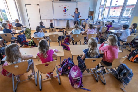 Teacher Francie Keller welcoming the pupils of class 3c in her classroom in the Lankow primary school to the first school day after the summer holidays in Schwerin, Germany, on 3 August 2020.