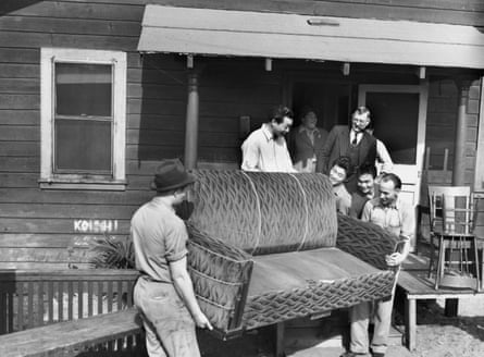men carry a sofa out of a home